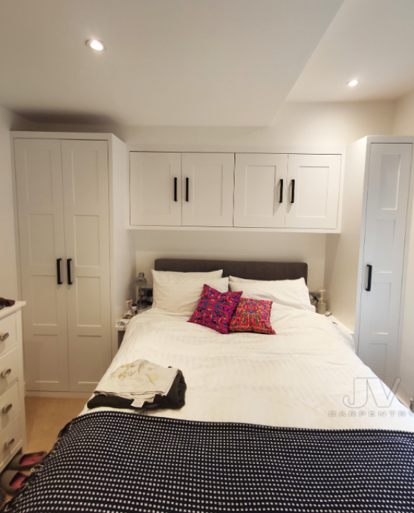 Kamar tidur dengan lemari gantung di atas tempat tidur